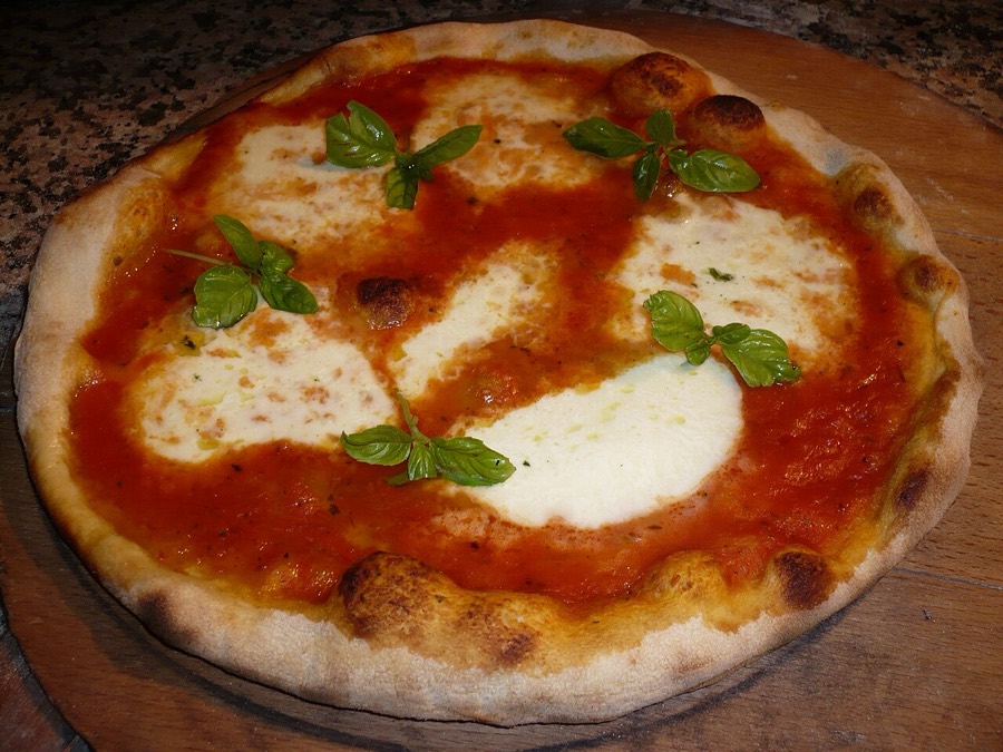 A Neapolitan margherita pizza with mozzarella, tomato and fresh basil